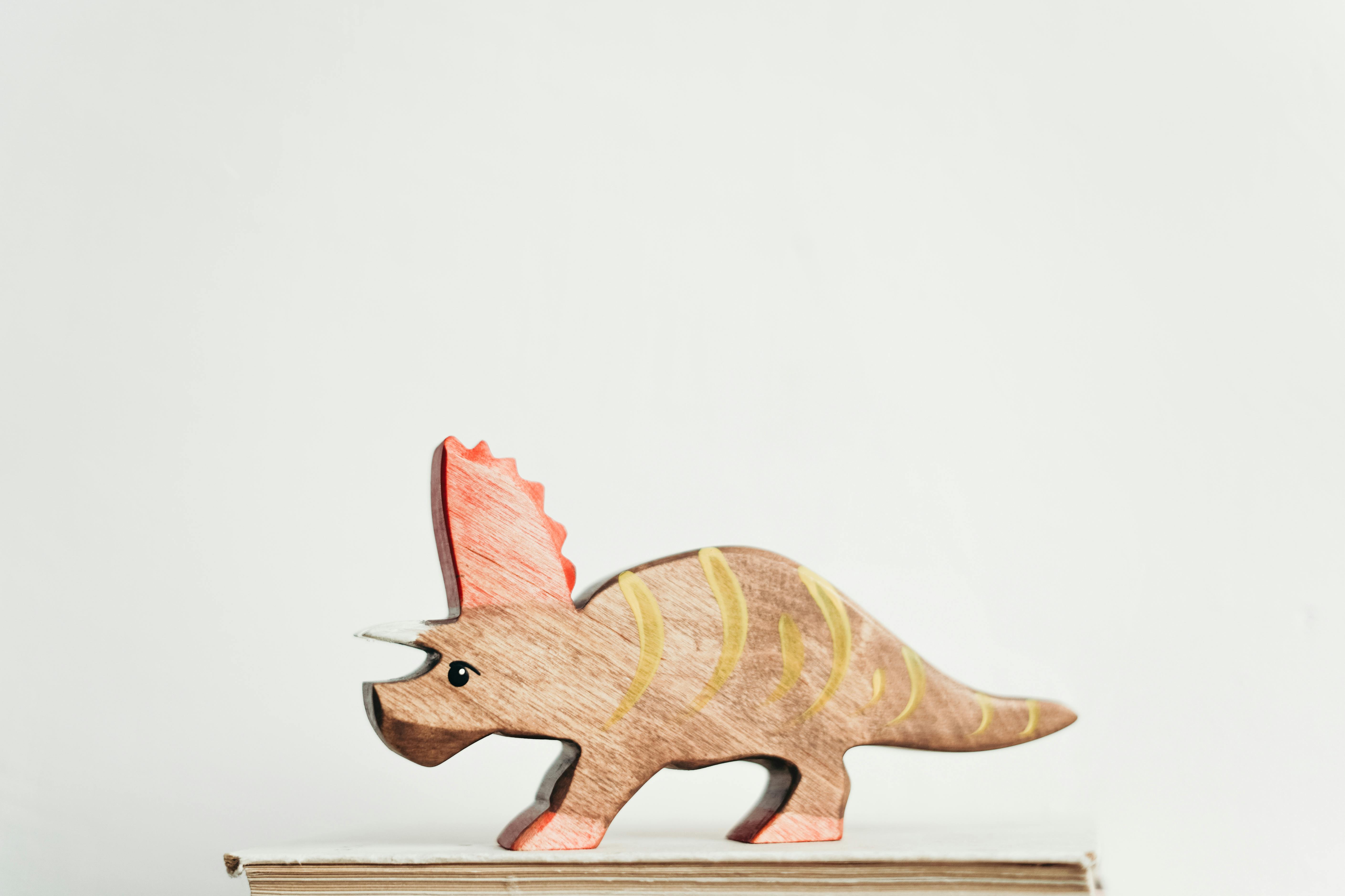 brown and yellow dinosaur toy