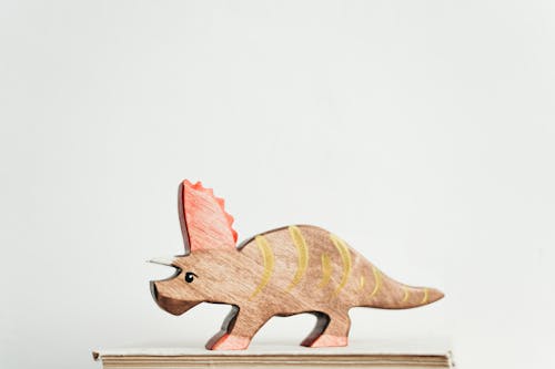 Free Brown and Yellow Dinosaur Toy Stock Photo