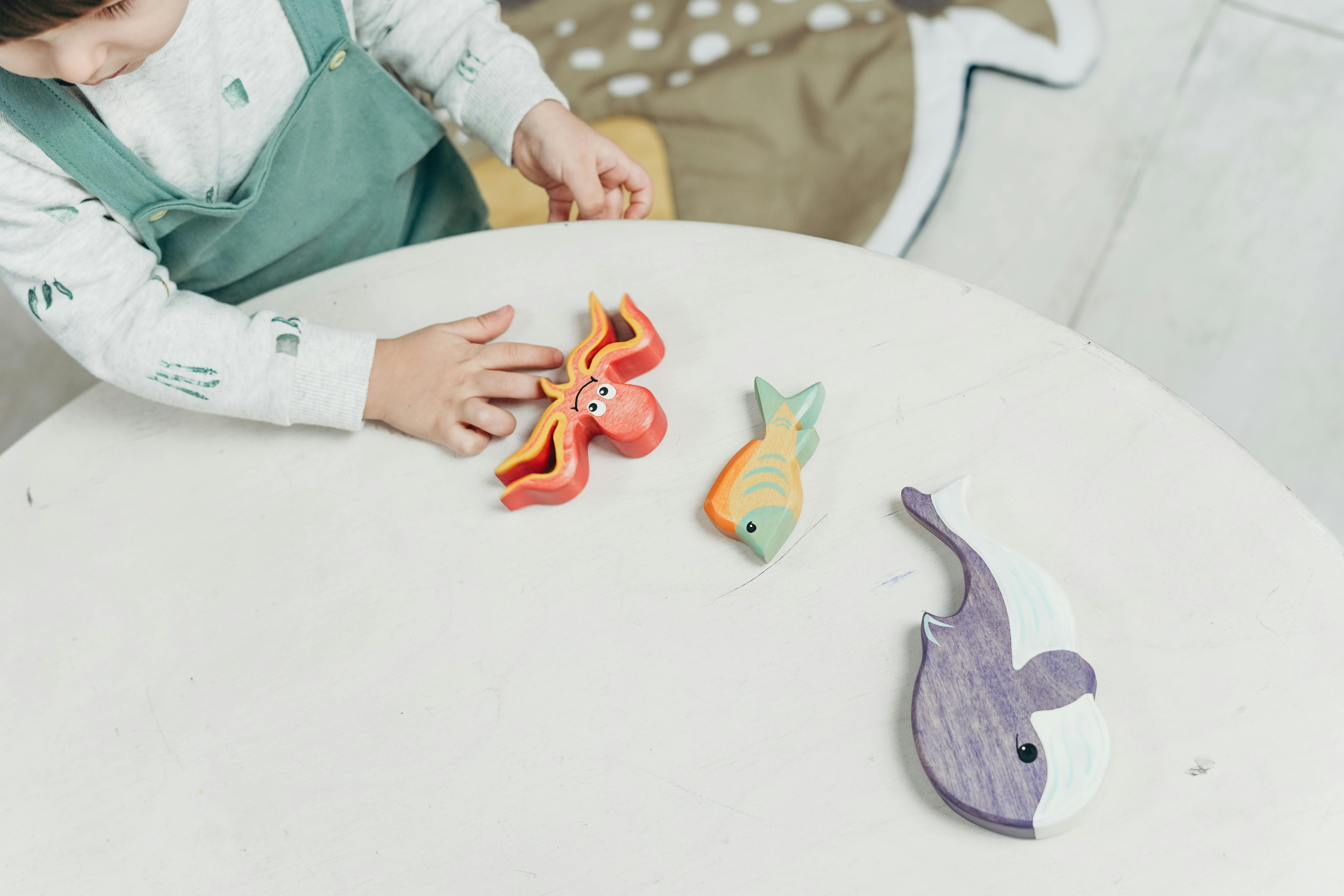 girl playing with wooden toys