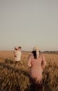 Family Stroll Through Golden Wheat Field