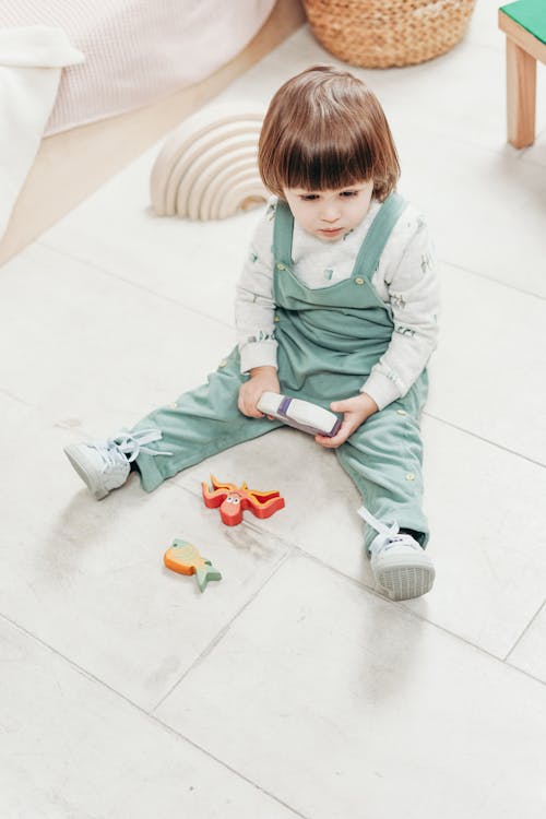 Free A Child Sitting On The Floor With Toys  Stock Photo