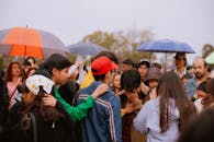 Community Gathering Under Umbrellas on Overcast Day