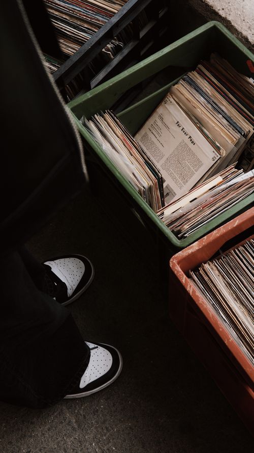 Free A person browsing vintage vinyl records in a crate at a record store. Stock Photo