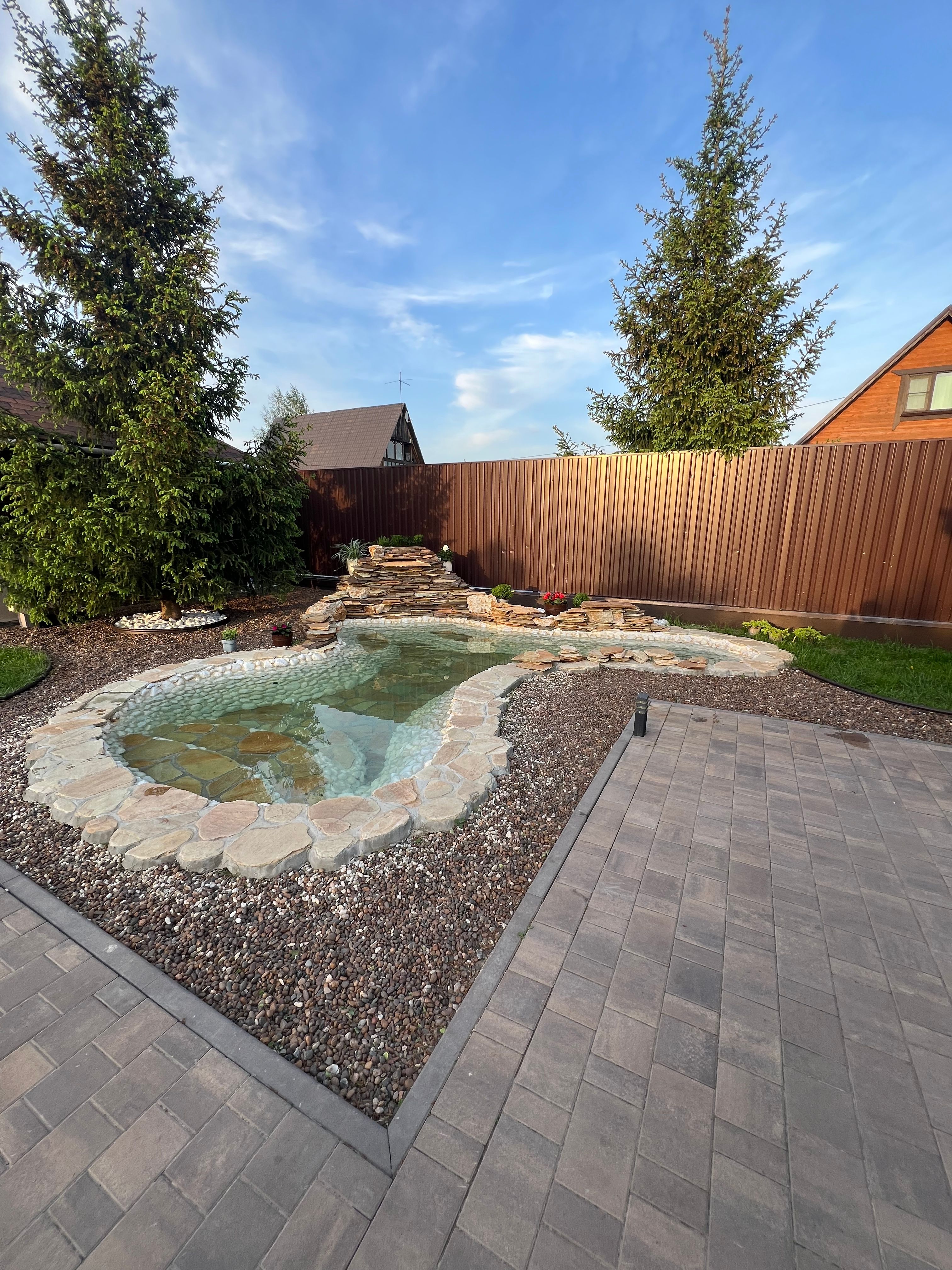 Residential home with landscaped yard and outdoor features
