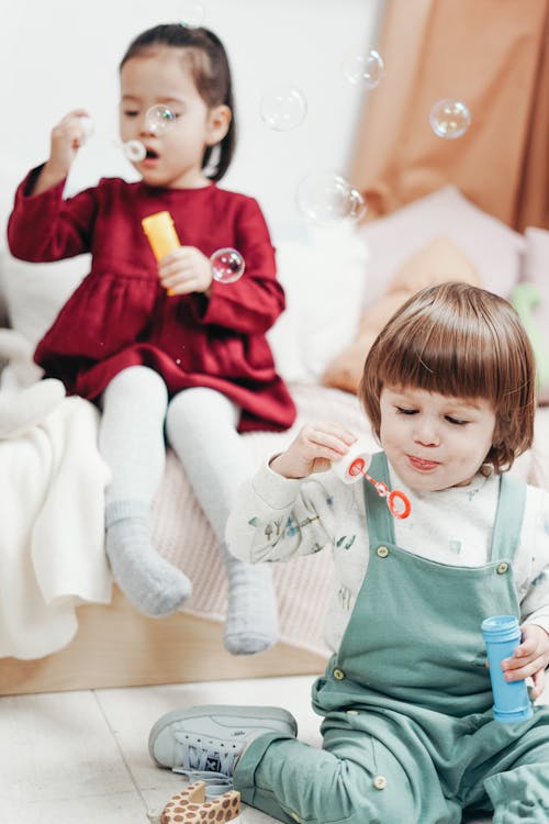 Free Two Children Playing with Bubble Blower Stock Photo