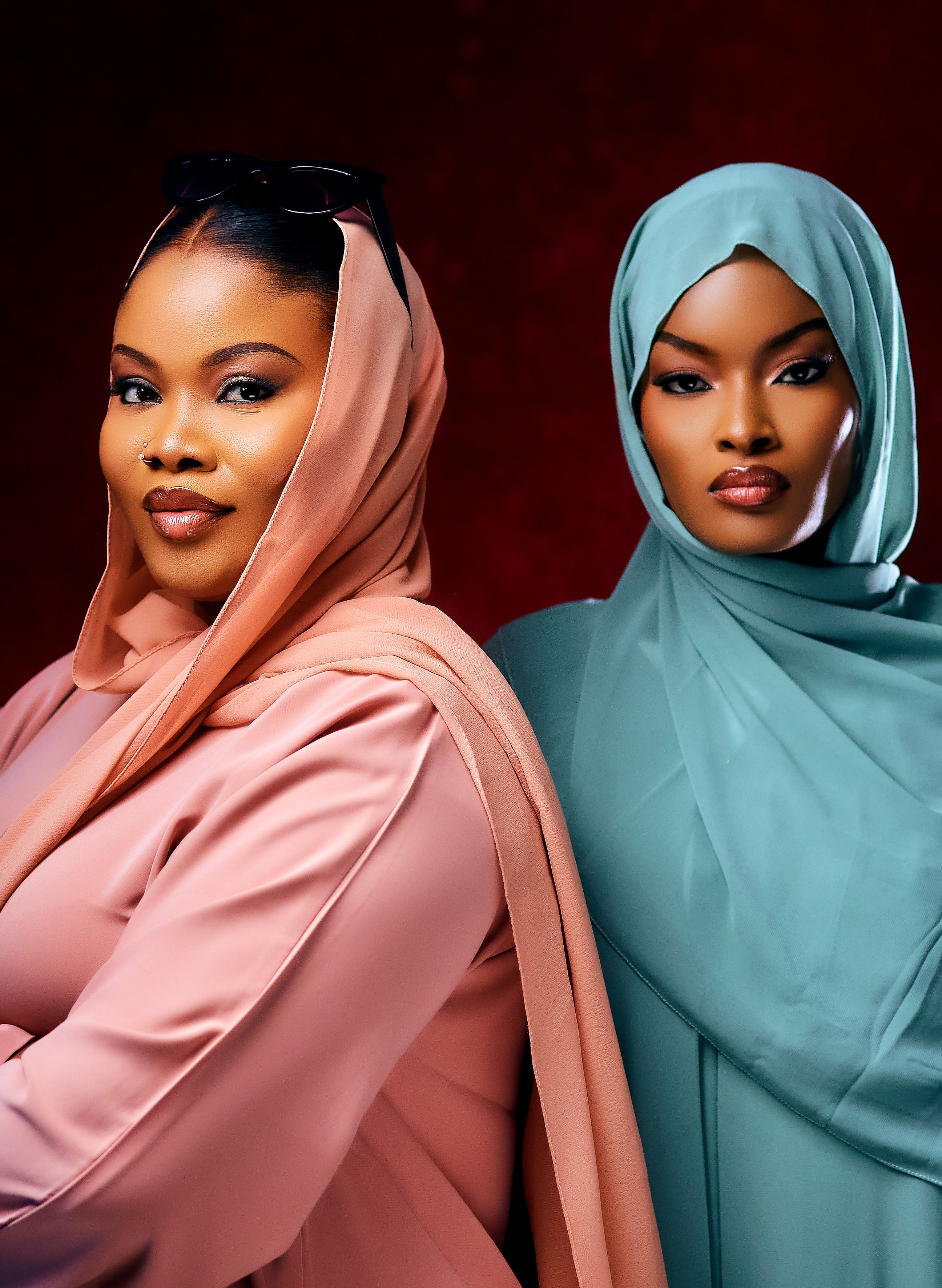 Stylish portrait of two women wearing elegant hijabs with rich colors.