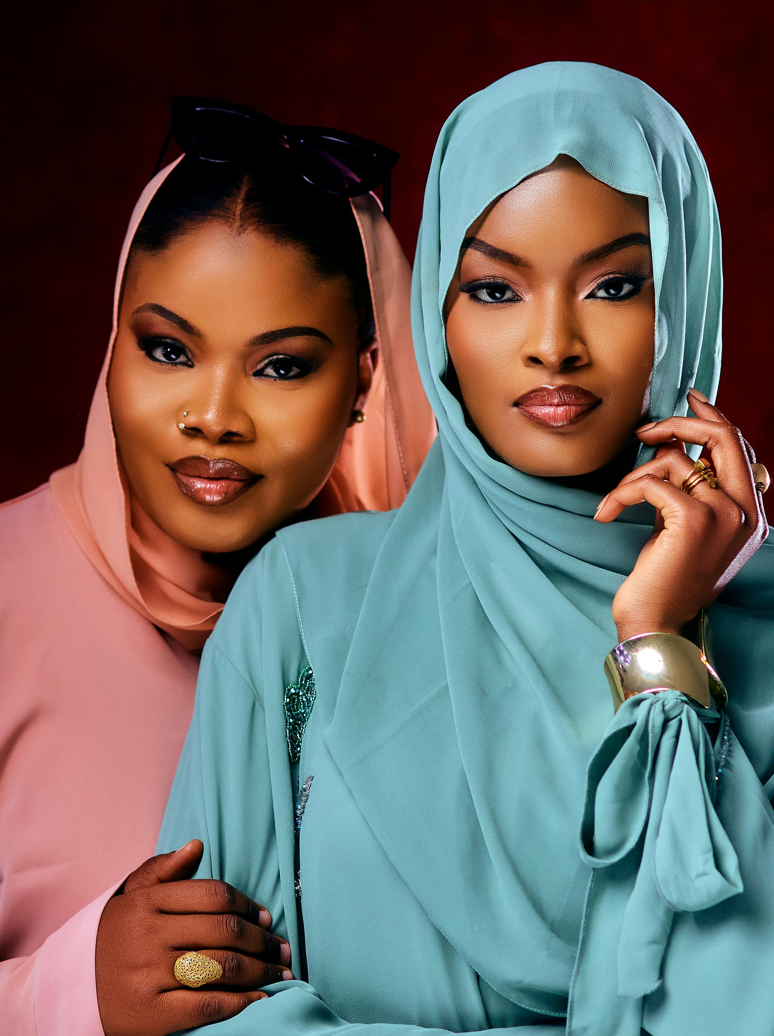 Close-up portrait of two elegantly dressed women wearing stylish hijabs.