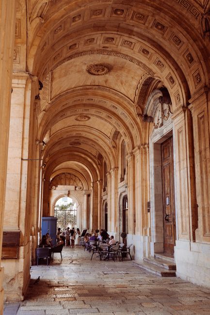 A stunning view of classic arches and stonework in Valletta, Malta. Perfect for architecture enthusiasts.