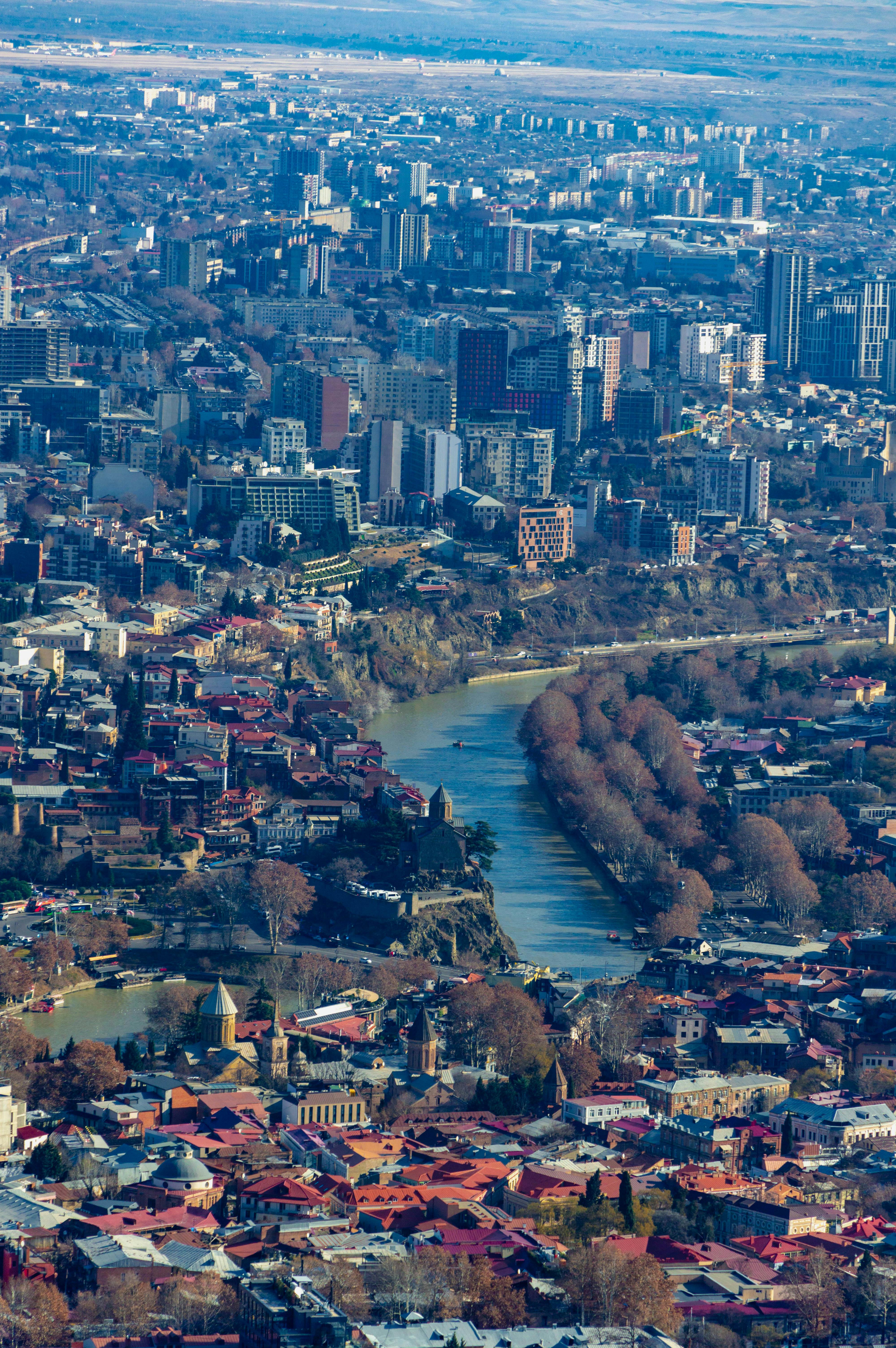 Безкоштовне Аерофотознімок міського пейзажу Тбілісі, Грузія, з звивистою річкою та різноманітною архітектурою. стокове фото