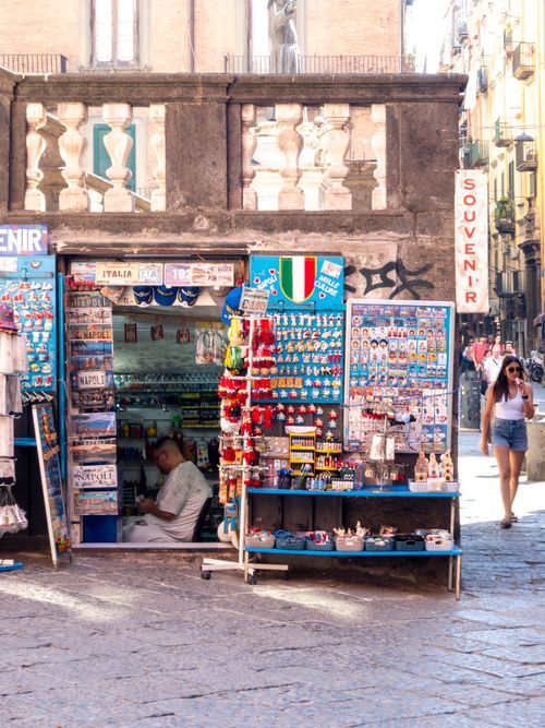 Free Explore a lively Italian souvenir shop in Naples, full of colorful trinkets and bustling with visitors. Stock Photo
