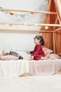 Girl in Red Dress Playing on Bed
