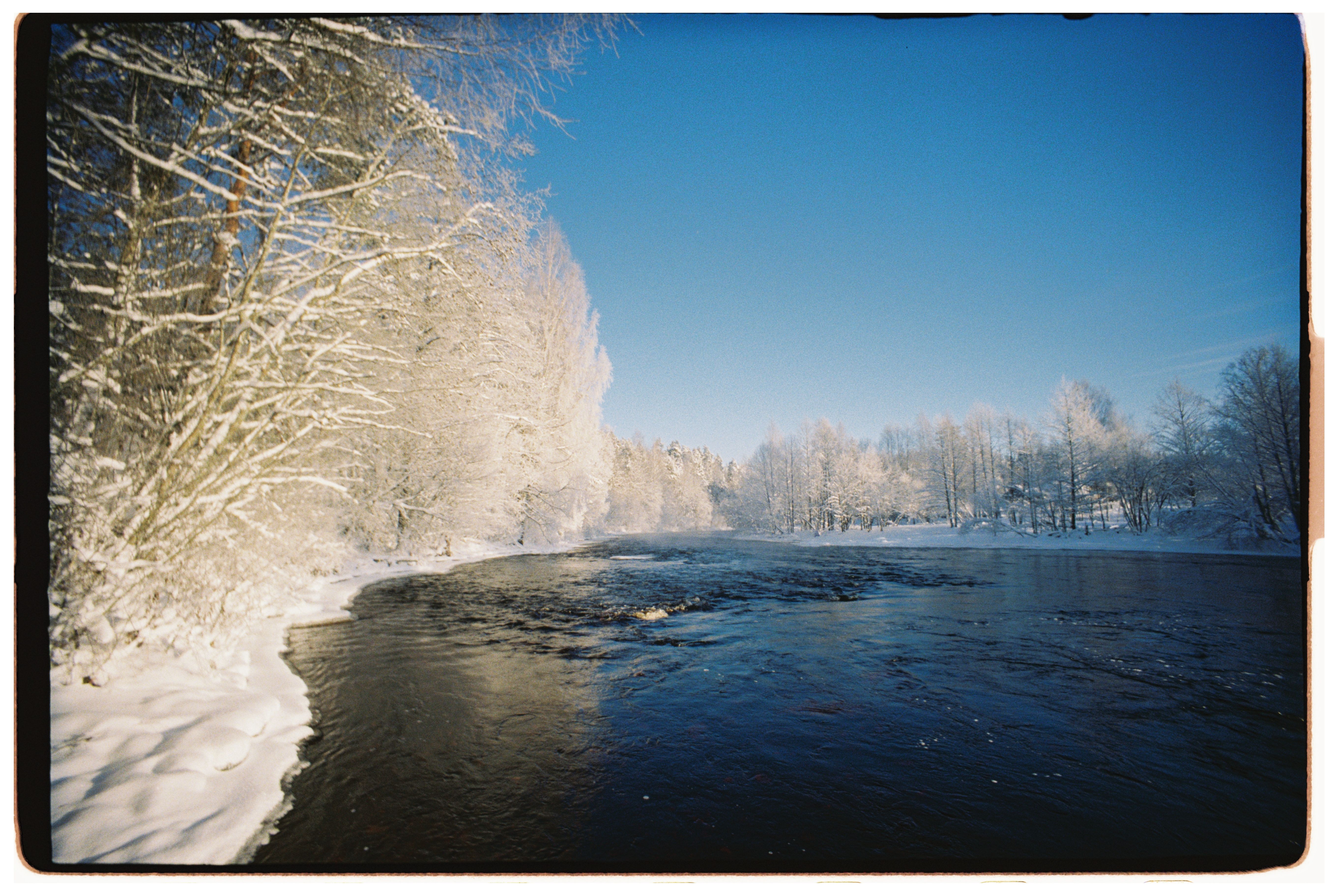 Serene Winter Landscape with Snowy River · Free Stock Photo