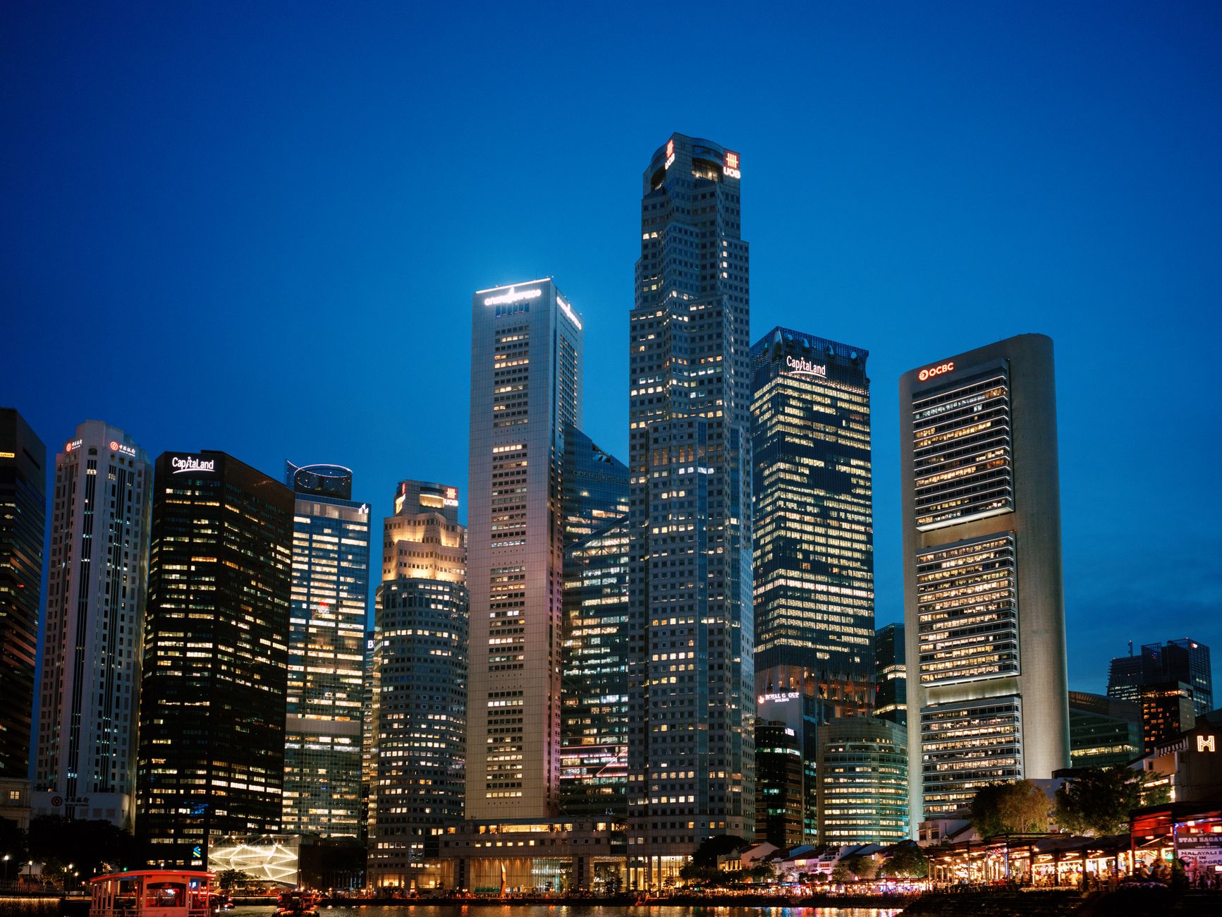 Stunning view of Singapore's financial district skyline at night with illuminated skyscrapers. (Photo by Gatsby Yang on Pexels)