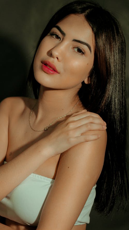 Portrait Photo of Woman in White Tube Top Posing