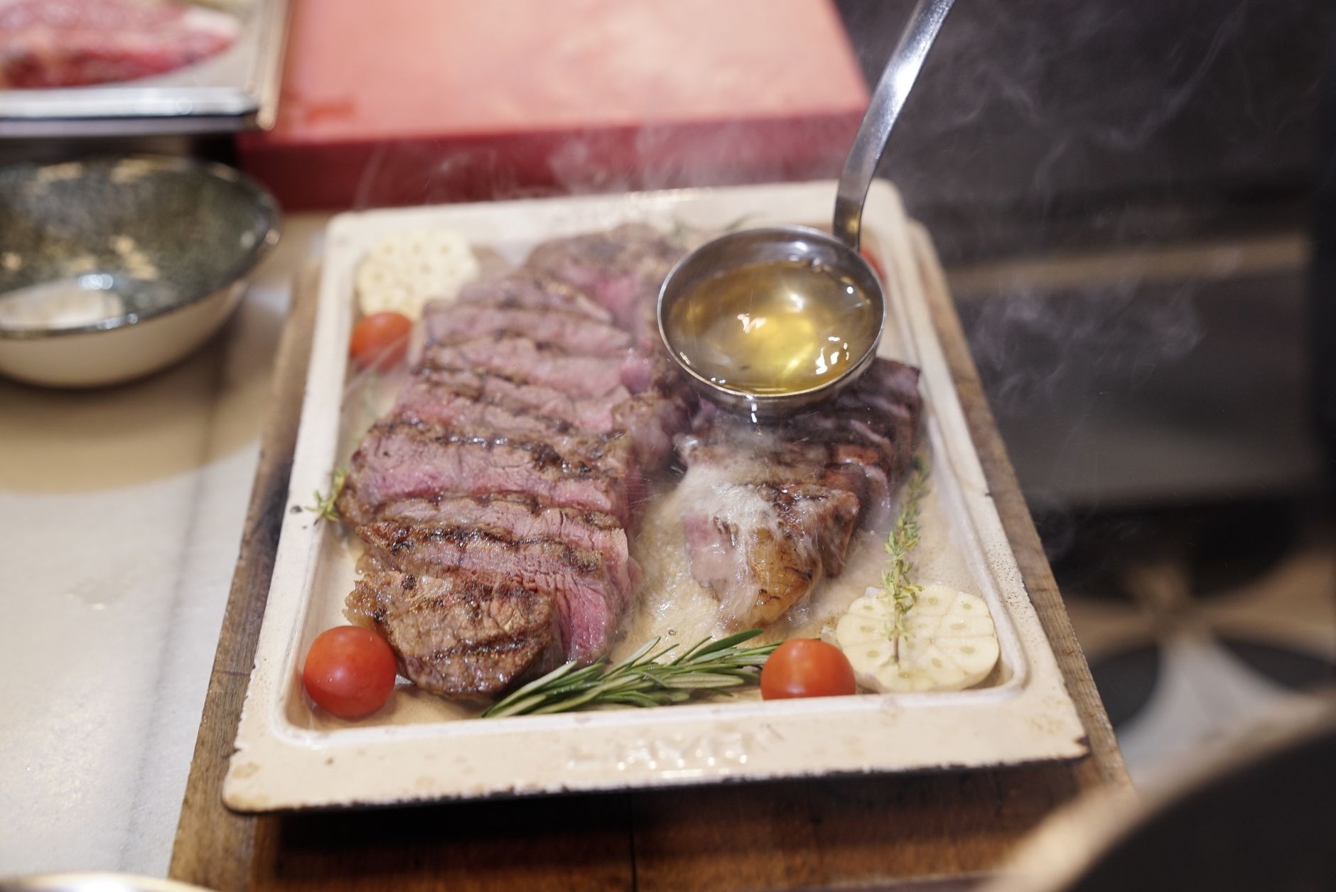 Top down air fryer steak ready to serve with garlic herb butter