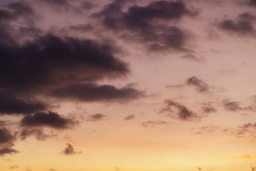 Free A breathtaking view of a dramatic sunset sky with dark clouds creating a moody atmosphere. Stock Photo
