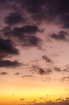 A vibrant and dramatic sunset with purple clouds and orange hues creating a stunning sky landscape.