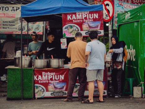 Lively street food scene at a Jakarta bazaar with diverse local cuisine.