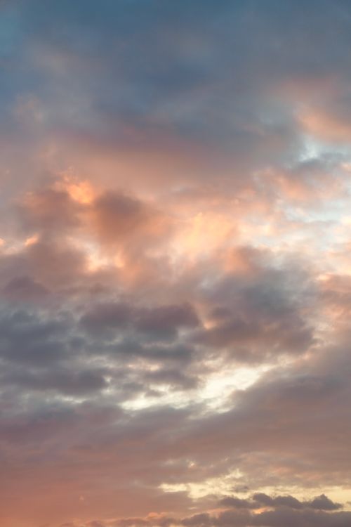 Free Capture of a colorful sunrise sky with soft pastel clouds and warm tones. Stock Photo