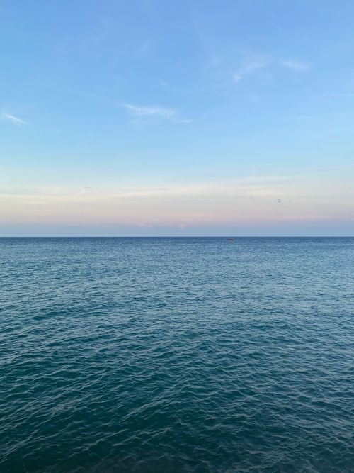 Free Tranquil ocean scene at dusk with calm waters and a pastel sky, captured in Banda Aceh, Indonesia. Stock Photo