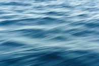 Artistic blur effect of ocean waves capturing fluid motion and dynamic texture.