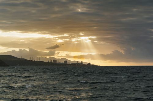 Free Stunning ocean view at sunset with dramatic clouds and sunbeams shining through. Stock Photo