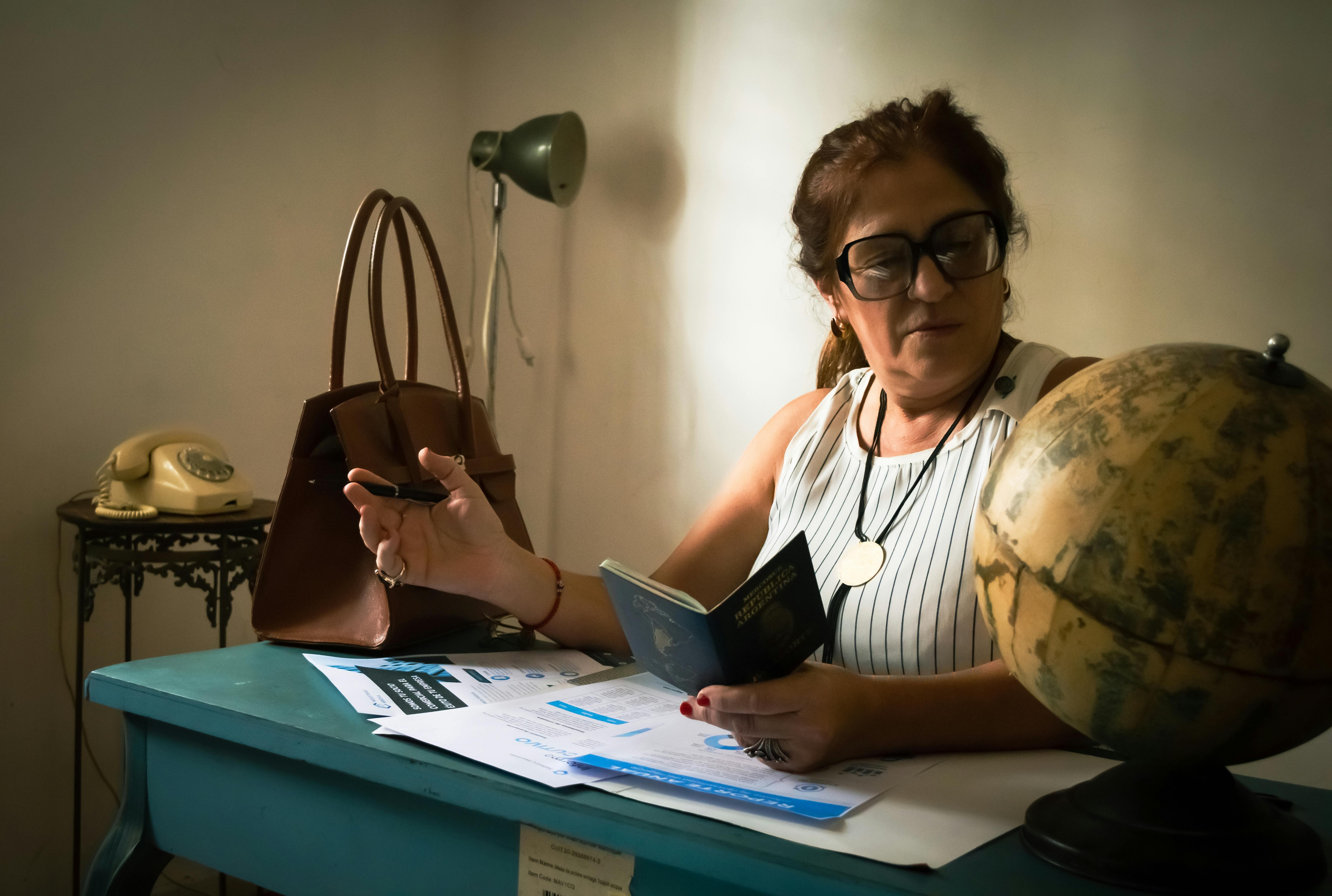 immigration officer behind a glass checking a passport