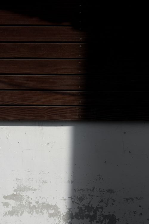 Free A minimalist composition featuring dramatic shadows on a textured wall, emphasizing light interaction. Stock Photo