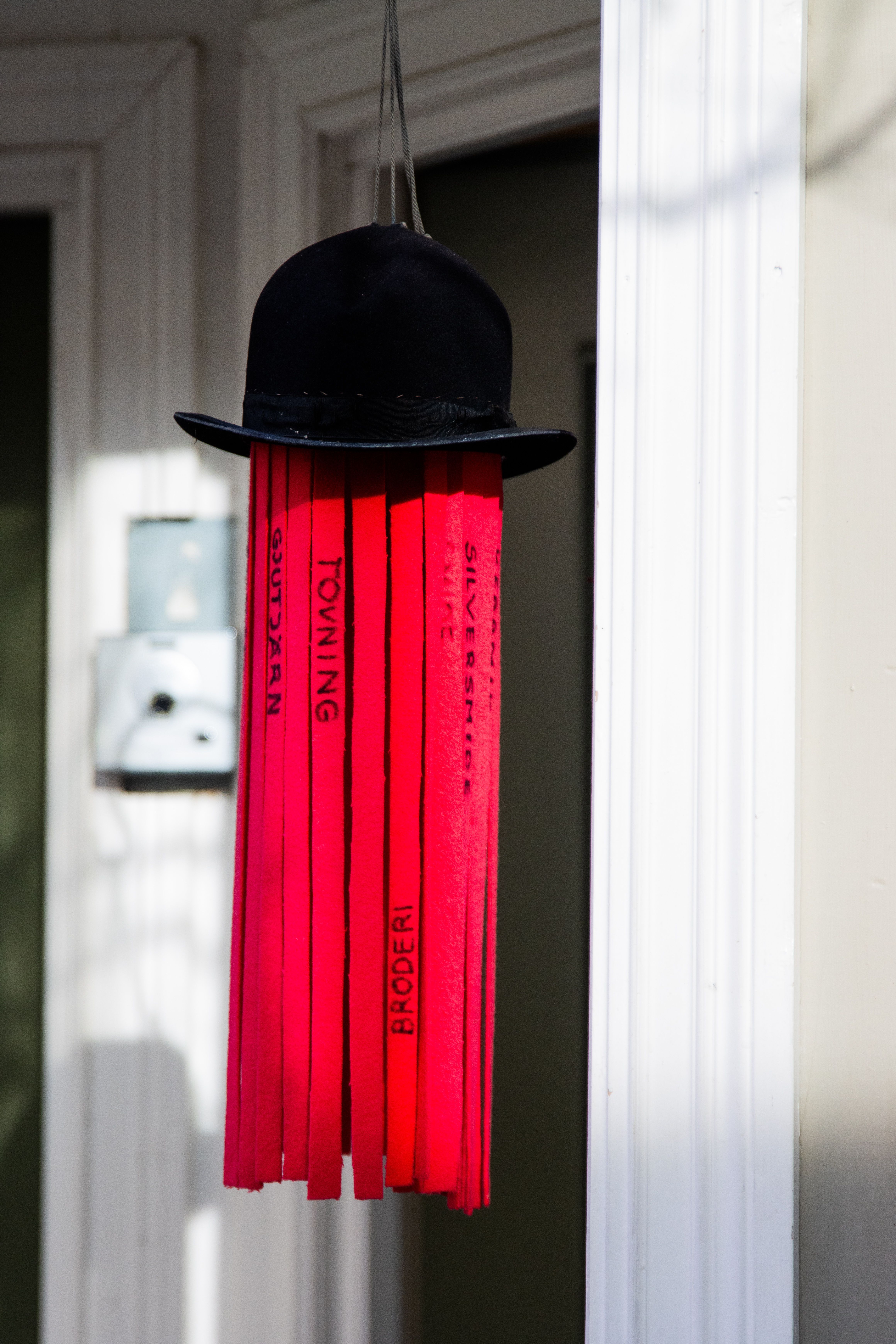 Hanging Red Streamers with Black Hat Decoration · Free Stock Photo