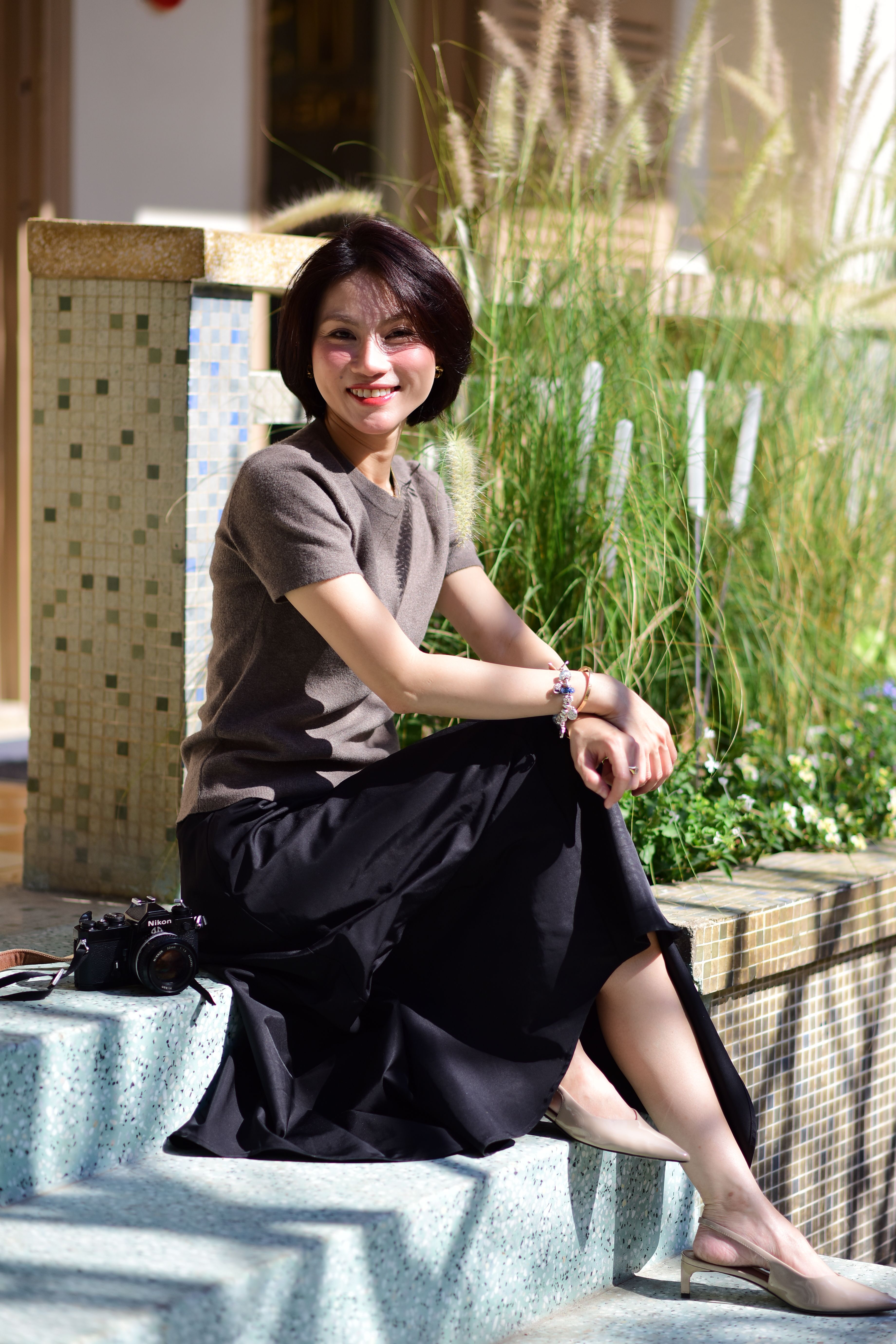 Woman Relaxing Outdoors in Stylish Summer Outfit · Free Stock Photo