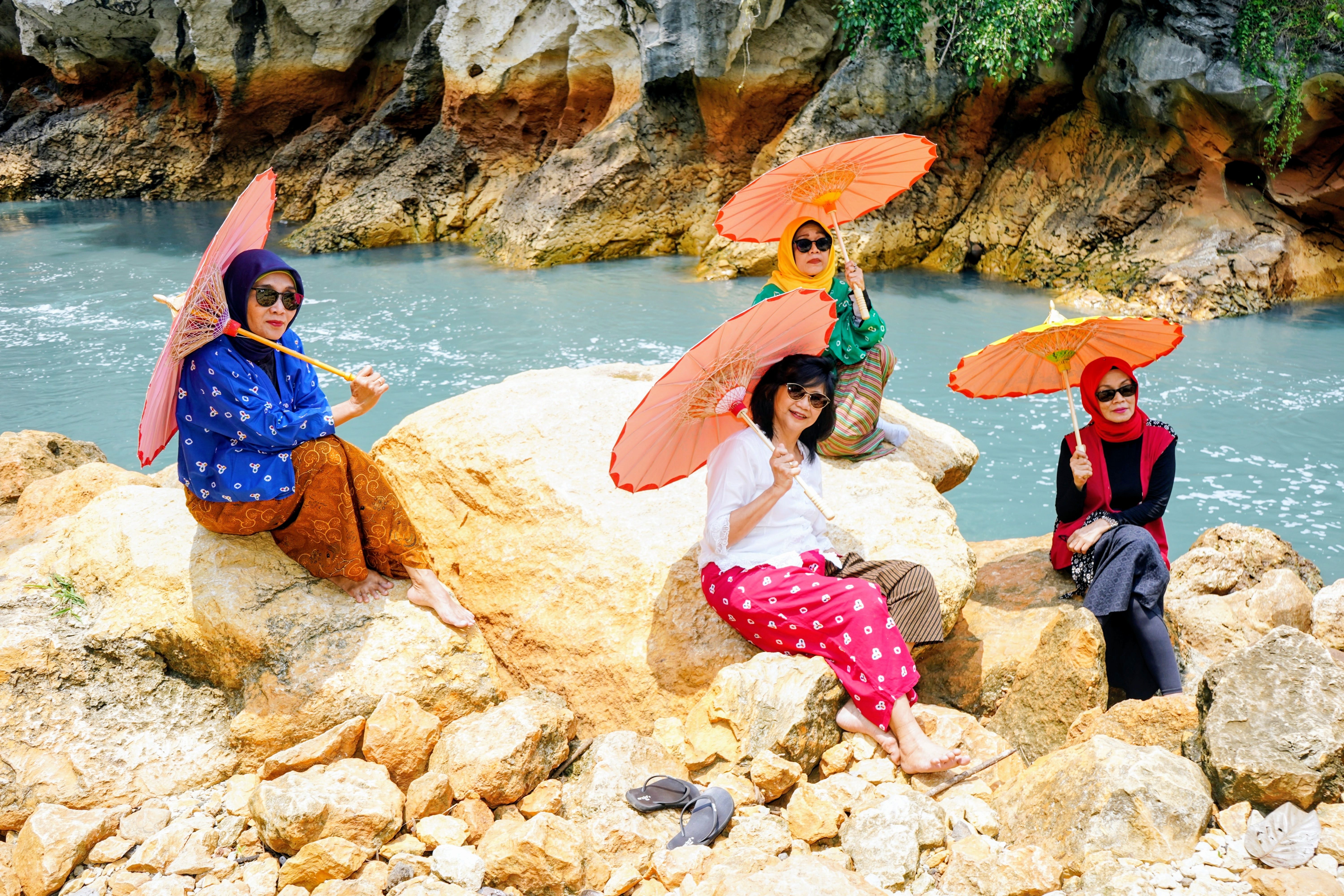 Women with Parasols by a River in West Java · Free Stock Photo