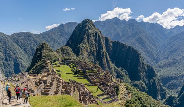 Breathtaking view of Machu Picchu with Andes Mountains under clear blue sky.