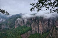 Misty Mountain Cliffs with Lush Greenery