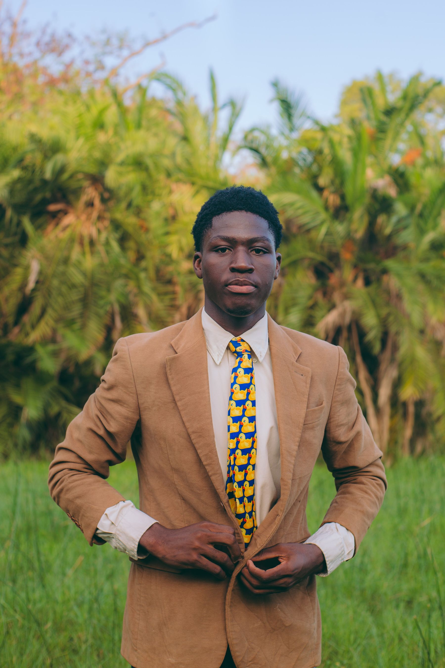 A tan blazer worn open in Accra.