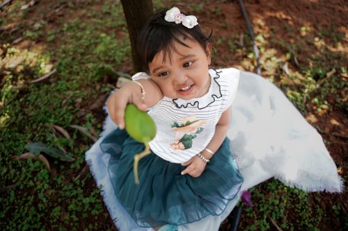 Free Charming photo of a child joyfully interacting with nature, showcasing innocence and playfulness. Stock Photo