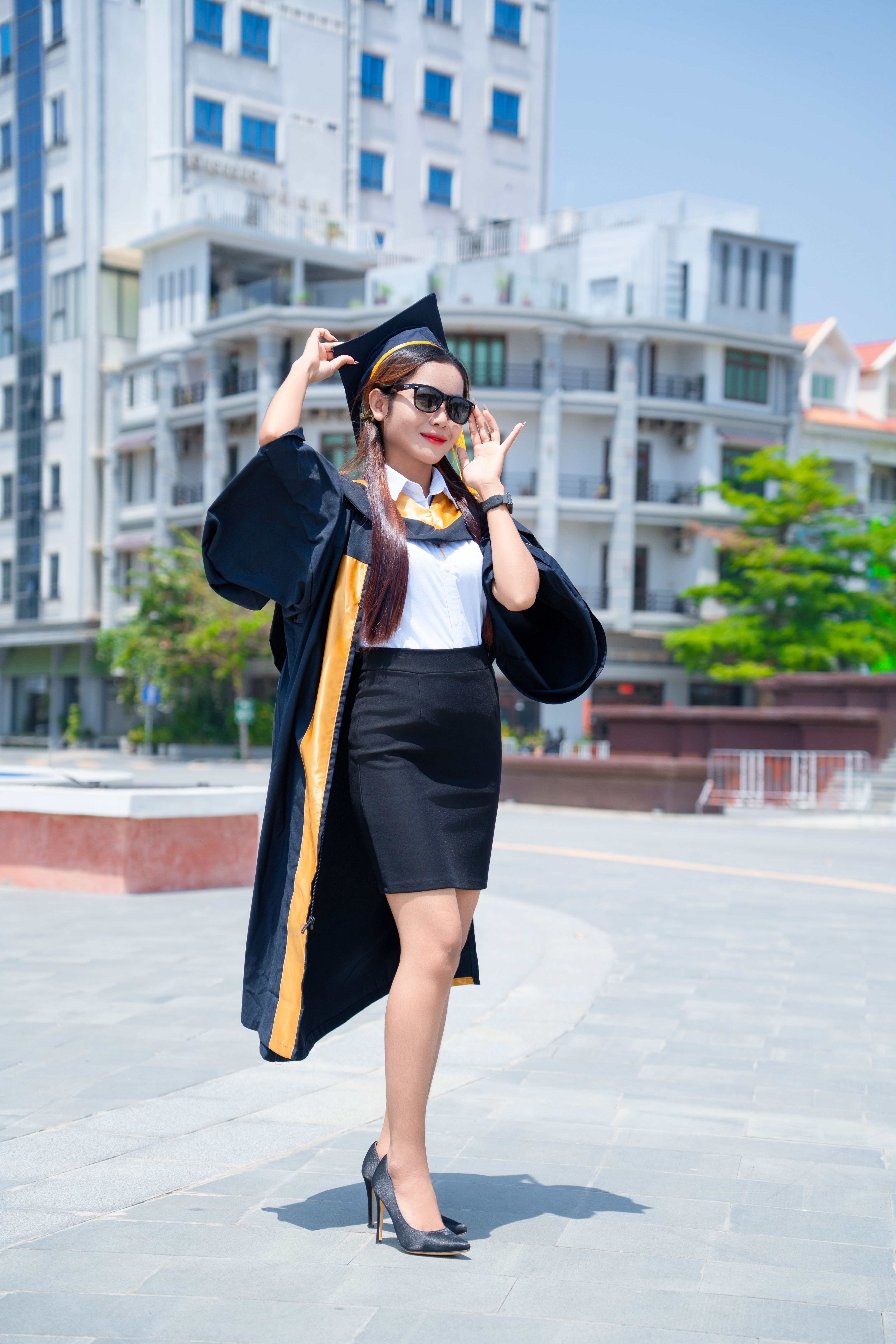Confident Graduate Posing Outdoors in City · Free Stock Photo