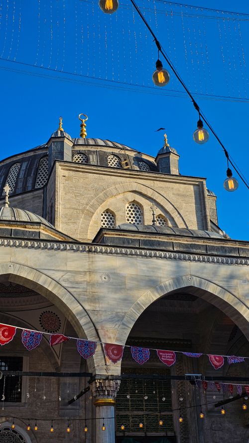 Free Detailed view of a mosque dome in İstanbul during daytime with decorative lighting. Stock Photo