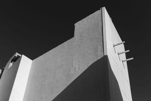 Free Monochrome image capturing minimalist architecture with sharp lines under a clear sky. Stock Photo
