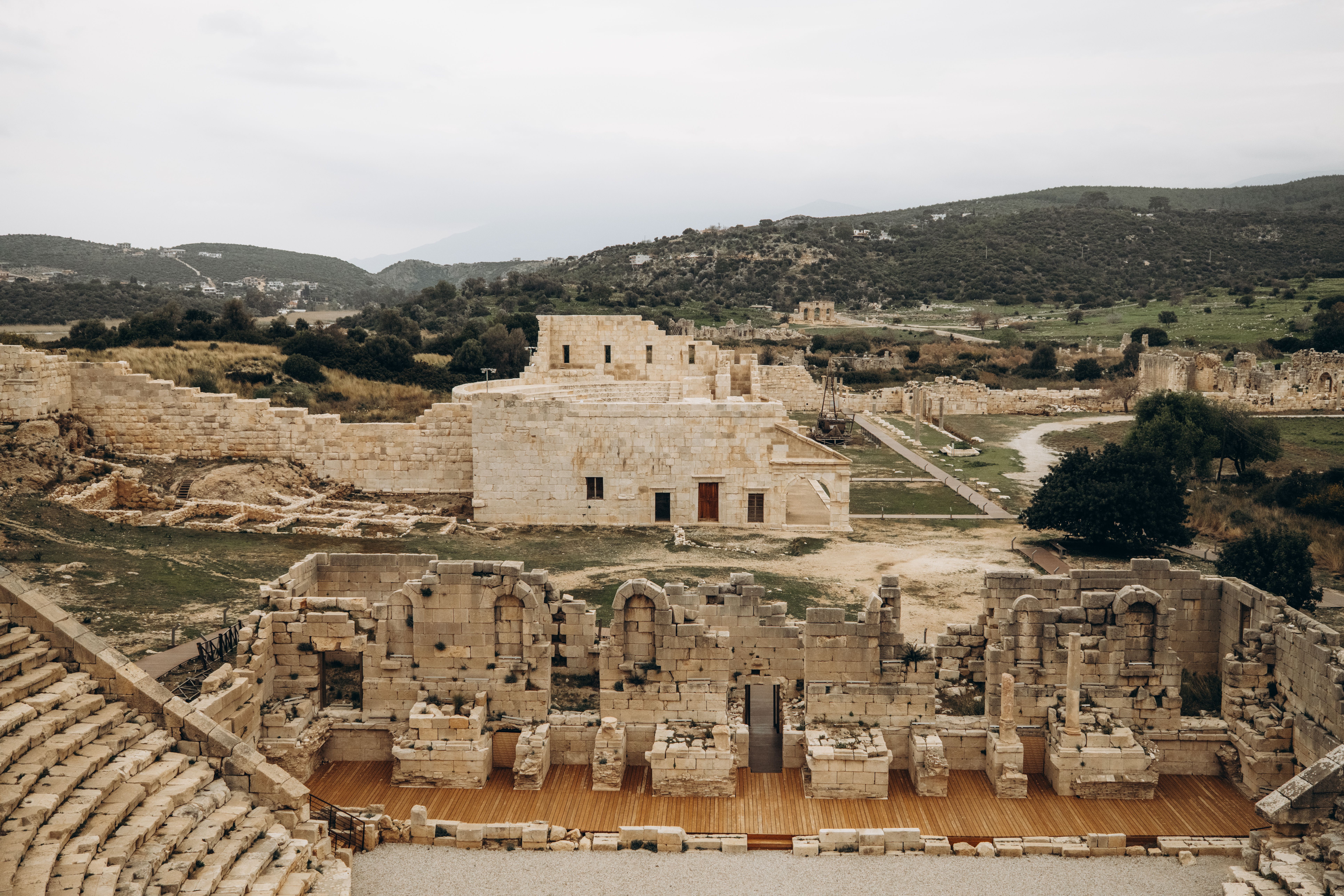 Explore ancient Roman ruins in a scenic Mediterranean landscape, showcasing historical architecture.