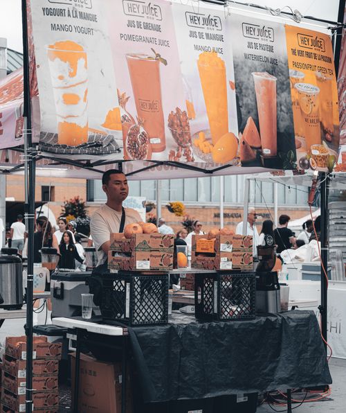 Free Juice vendor at Mississauga cultural festival with diverse crowd enjoying summer vibes. Stock Photo