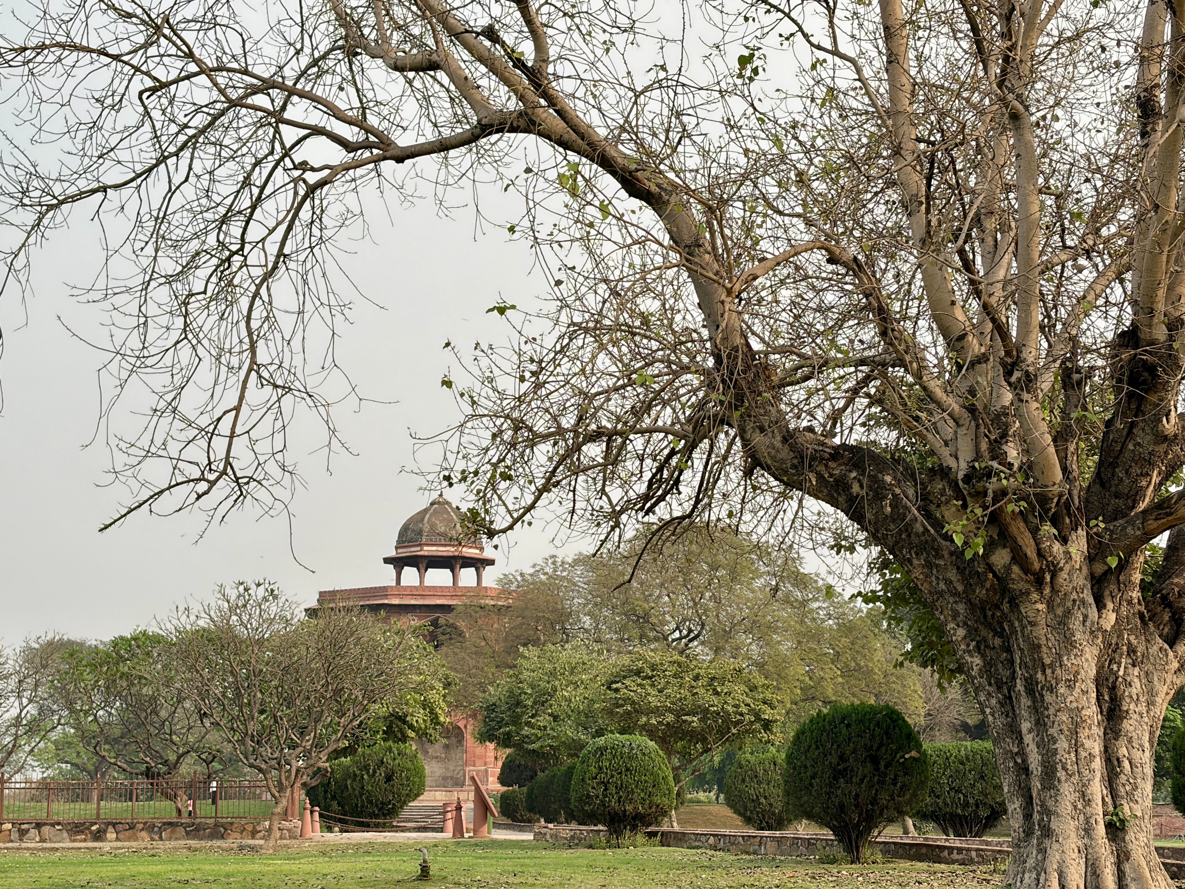 Restored Mughal pavilion and lawns in a Delhi heritage park at sunrise
