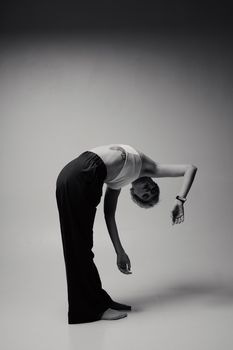 Artistic black and white photo of a dancer in a unique, dynamic pose.