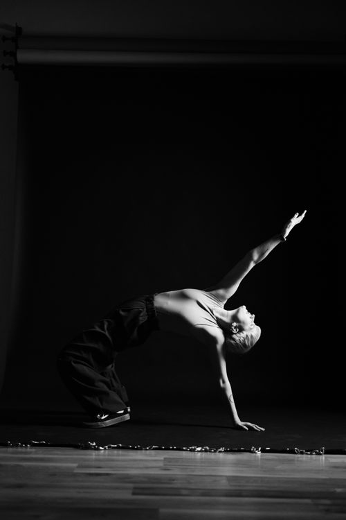 Free Black and white photo of a dancer in an artistic bridge pose capturing elegant motion. Stock Photo