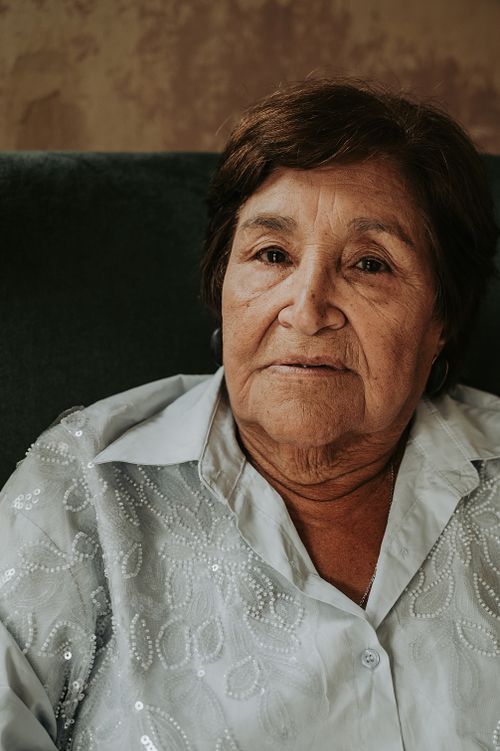 Free A thoughtful portrait of a senior woman wearing a sequined blouse in Buenos Aires. Stock Photo