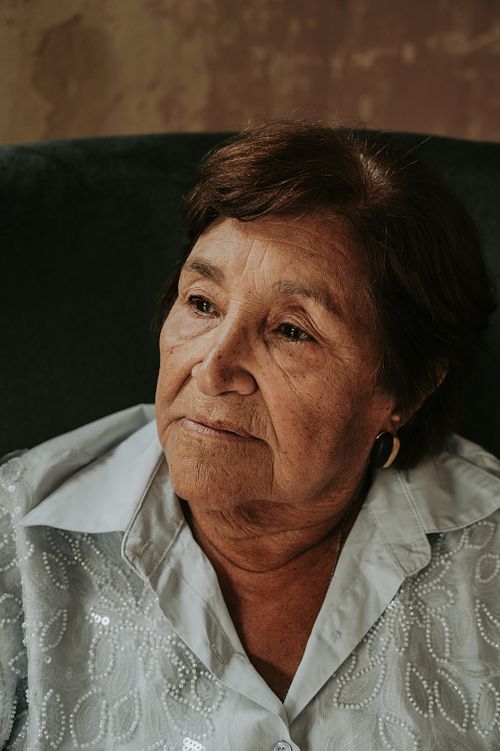 Free Portrait of an elderly woman with thoughtful expression indoors in Buenos Aires, Argentina. Stock Photo