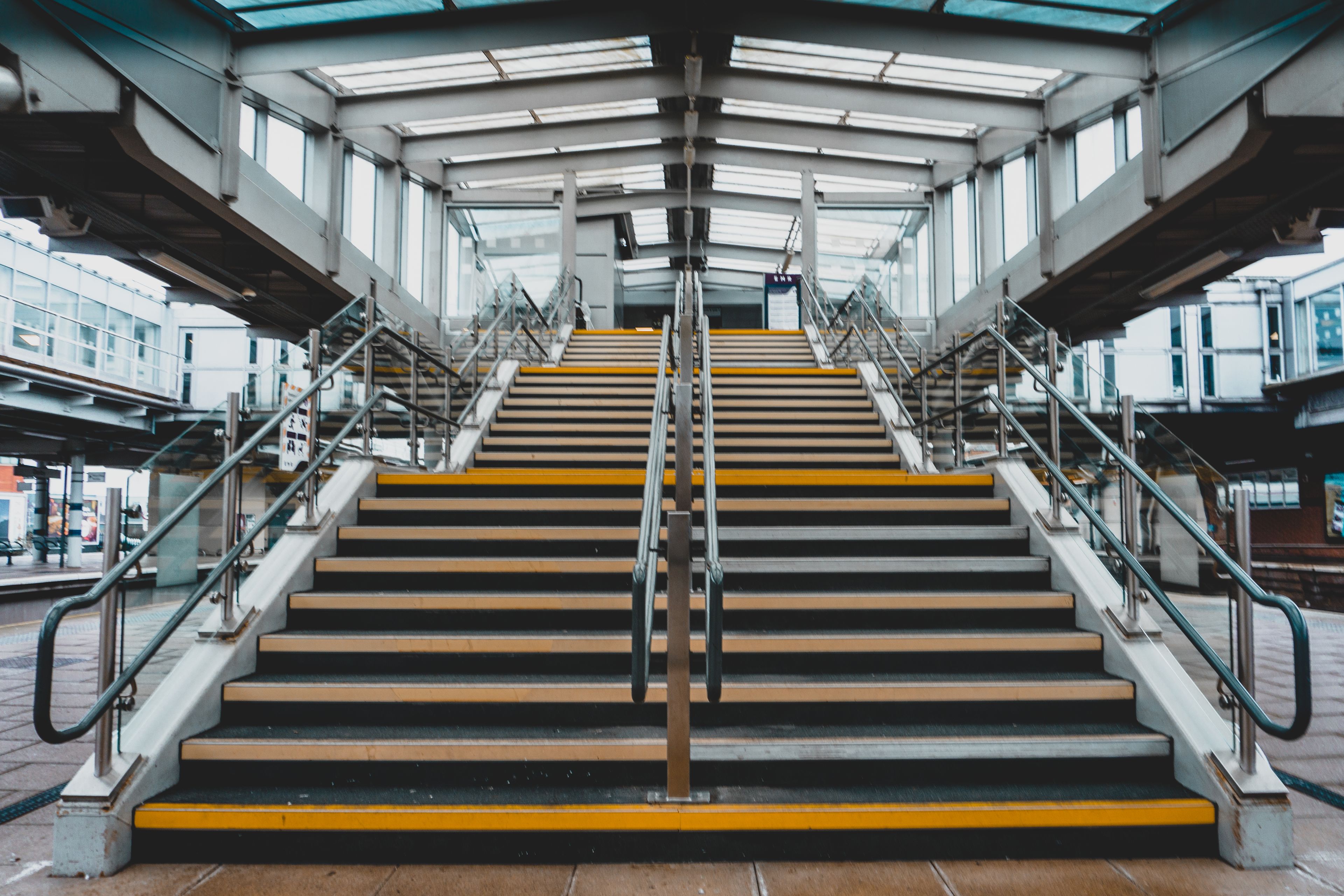 A wide staircase with stainless-steel handrails