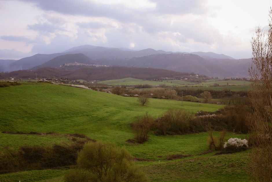 Breathtaking landscape view of verdant hills in Anagni, Lazio, Italy with mountains in the background.