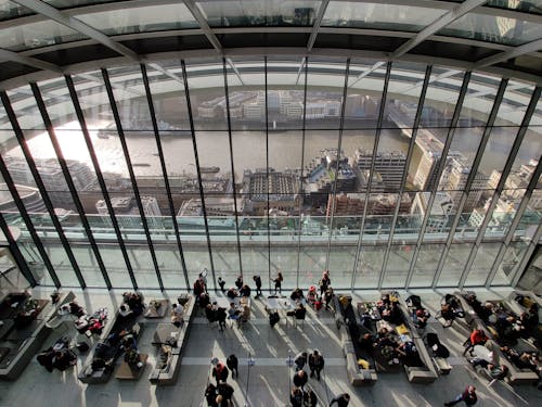 People Sitting on Bench Inside Building