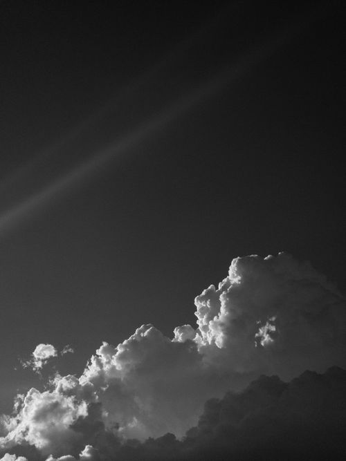 Free A striking black and white photograph capturing dramatic clouds during twilight. Stock Photo