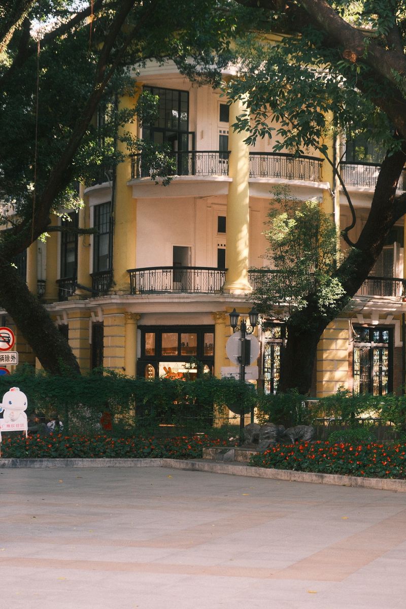 Yellow colonial-era buildings surrounded by trees on Shamian Island